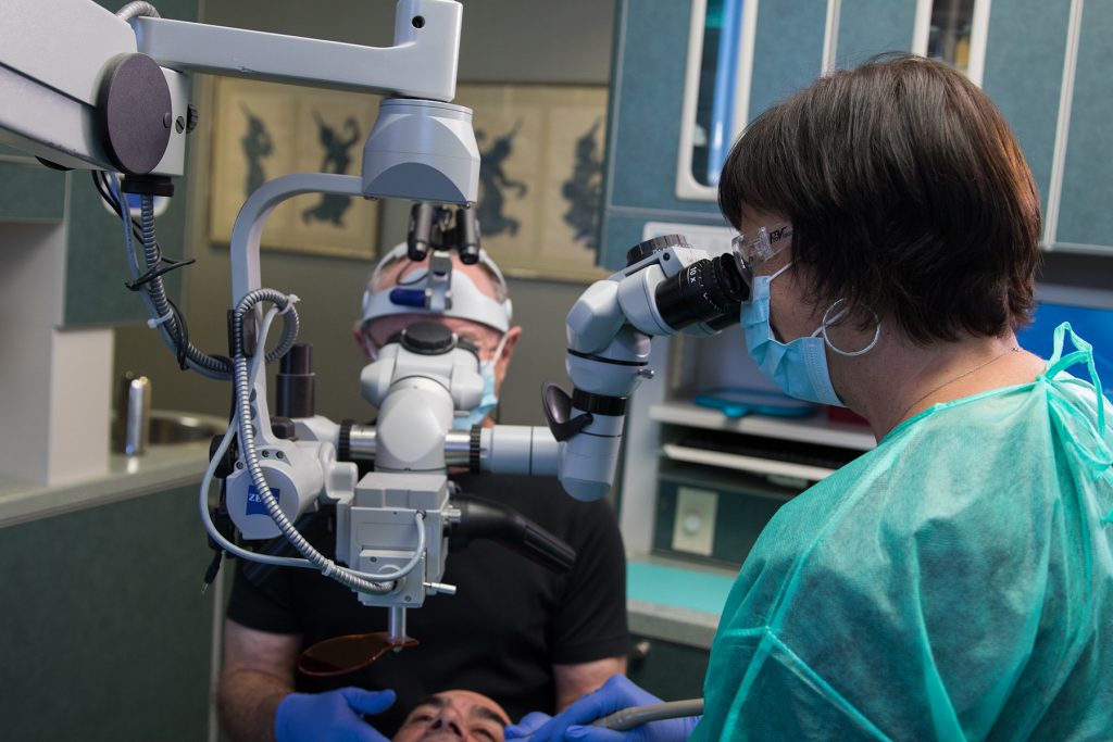 Doctor using equipment with patient